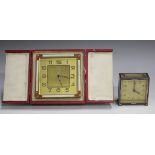 An Art Deco gilt metal and enamelled bedside alarm clock, the gilt dial with Arabic hour numerals,