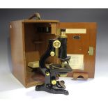 An early 20th century black enamelled and lacquered brass monocular 'Service' microscope, signed 'W.