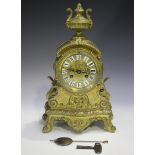 A late 19th century French brass cased mantel clock with eight day movement striking on a bell via