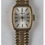 A Tissot 9ct gold lady's bracelet wristwatch, the signed curved rectangular silvered dial with black