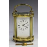 An early 20th century French brass oval cased carriage timepiece with eight day movement, the