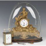 A late 19th century gilt spelter mantel timepiece with eight day movement, the circular enamel