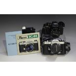 A Pentax KM camera with Pentax-M 1:2.8 35mm lens, together with a Pentax Program A camera with SMC