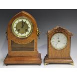 An Edwardian walnut mantel clock with eight day movement striking on a gong, the chapter ring with