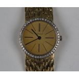 A Piaget 18ct gold and diamond set lady's bracelet wristwatch, the signed gilt dial with black