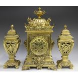 A late Victorian brass cased mantel clock with eight day movement striking on a gong, the pierced