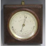 An Edwardian mahogany cased aneroid wall barometer, the silvered circular dial with alcohol