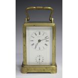 A late 19th century French brass one-piece cased carriage alarm clock with eight day movement