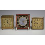 An Art Deco gilt metal and enamelled square bedside timepiece, the dial with mauve enamel centre