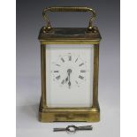 A late 19th/early 20th century brass corniche cased carriage clock with eight day movement