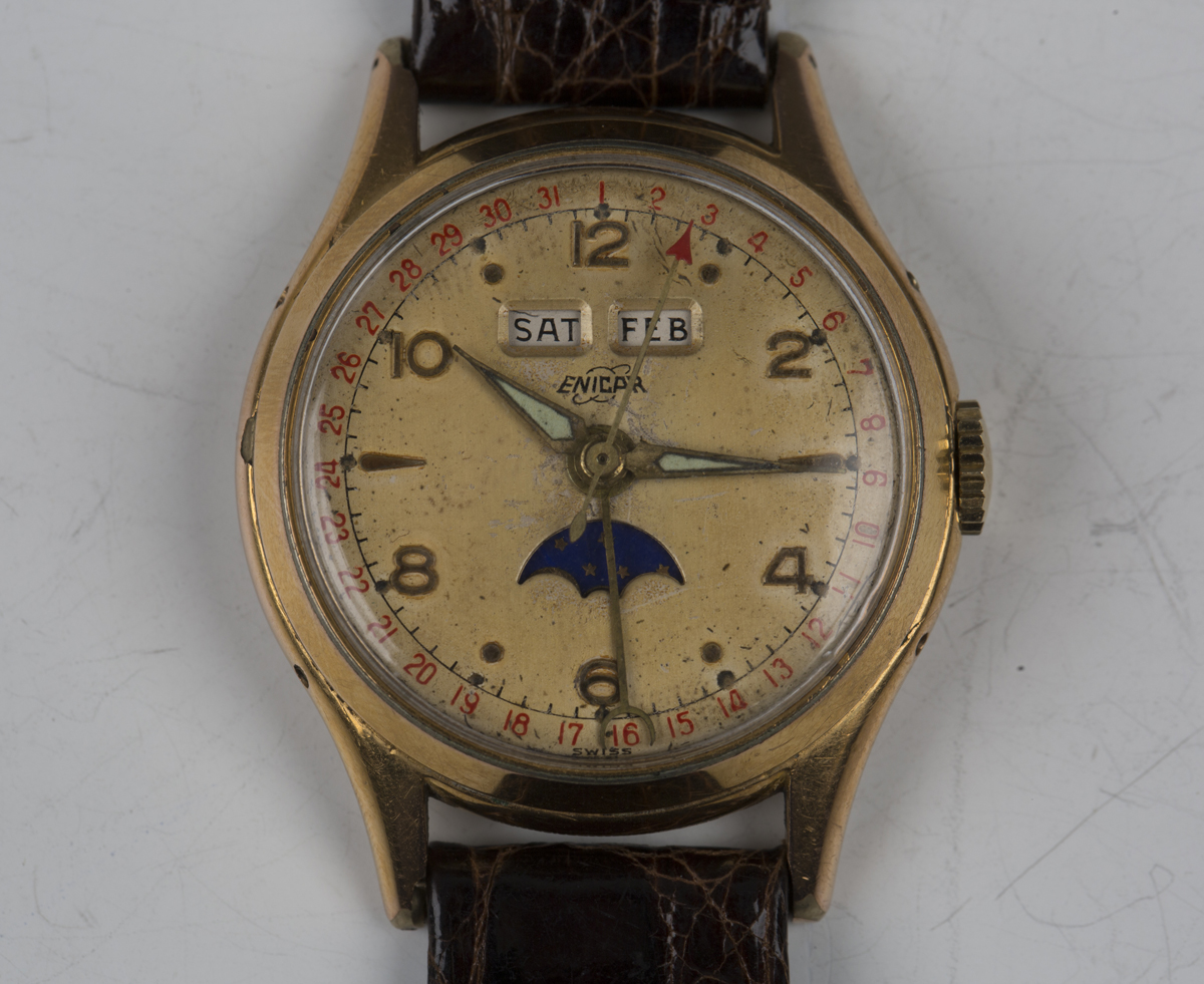 An Enicar gilt metal fronted and steel back triple calendar gentleman's wristwatch with signed