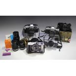 A collection of Olympus cameras and lenses, comprising OM-2 camera body, OM10 camera with Zuiko