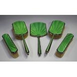 A George V silver and lime green enamelled five-piece dressing table set, comprising a hand