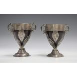 A pair of late 18th century white metal mounted coconut cups, each wide banded rim mount flanked