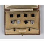 A 9ct gold, 18ct white gold and black onyx dress set, comprising a pair of cufflinks, four buttons