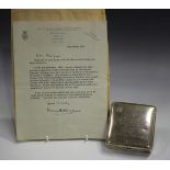 A George V silver cigarette box, the hinged lid with applied gold crest to upper left corner and