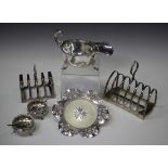 A group of silver items, comprising a sauceboat with flying scroll handle and gadrooned rim, on