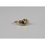 A gold ring, hinged to form hands enclosing a heart, detailed '14K', weight 4.1g, ring size approx
