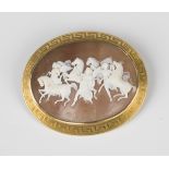 A gold mounted oval shell cameo brooch, mid-19th century, carved as four horses accompanied by three