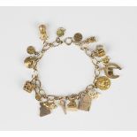 A gold oval link charm bracelet on a boltring clasp, detailed '9ct', fitted with a variety of mostly