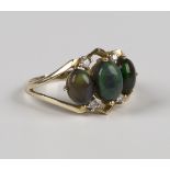 A 9ct gold ring, mounted with three oval cabochon dark opals with two pairs of circular cut diamonds