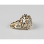 A gold and diamond cluster ring, in a shaped hexagonal design, mounted with circular and baguette