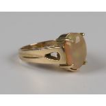 A gold ring, claw set with an oval opal, detailed '14K', weight 5.7g, ring size approx P.Buyer’s