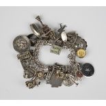 A multiple link charm bracelet, fitted with a variety of charms, including some American,