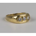 An 18ct gold and diamond three stone ring, mounted with circular cut diamonds, London 1979, weight