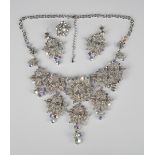 A Butler & Wilson style costume necklace, designed as skulls, length 47cm, with a matching pair of