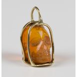 A gold mounted carved fire opal pendant, designed as a skull within a cage, detailed '585', weight