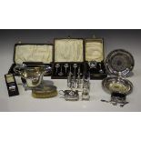 A group of silver items, including a George V sauceboat with flying scroll handle, London 1911, an