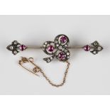 A gold and silver set, ruby and diamond brooch, circa 1900, with a trefoil shaped motif at the