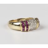 A gold, diamond and ruby ring in a domed design, mounted with three rows of circular cut diamonds to