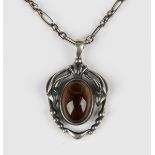 A Georg Jensen silver and smoky quartz pendant, circa 2014, of stylized foliate design, set with a