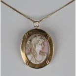 A gold mounted, carved pink shell cameo pendant, designed as a portrait of a lady with seed pearl