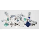A group of mostly silver jewellery, comprising thirteen pendants, including a bicolour tanzanite and