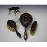 An Edwardian silver and tortoiseshell trinket box of rectangular form with curved sides, the