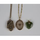 A gold pendant locket with scroll and foliate engraved decoration, detailed 'Real Gold', weight