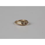 An 18ct gold ring, mounted with two cushion cut diamonds alternating with three cushion cut