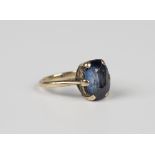 A gold ring, claw set with a cushion cut synthetic sapphire, unmarked, weight 3.5g, ring size approx