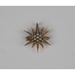A gold and seed pearl brooch, designed as a starburst, with a hook fitting, unmarked, weight 3.2g,