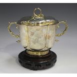 A silver gilt two-handled cup and cover, of lobed outline, flanked by a pair of cast scroll handles,