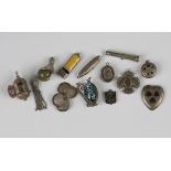 Five silver pendants and charms, including a cruciform compass, Birmingham 1886, an oval locket