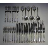 An Elizabeth II harlequin part canteen of silver cutlery with stylized shell handles, comprising six