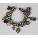 A decorated and plain multiple curblink charm bracelet, length 18.2cm, fitted with twelve pendants