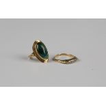 A gold ring, mounted with an oval malachite between beaded shoulders, unmarked, weight 3.7g, ring