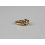 An 18ct gold and diamond three stone ring in an interwoven design, Birmingham 1915, weight 4.1g,