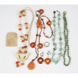 A group of Asian jewellery, comprising a cornelian pendant necklace, a single row necklace of