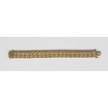 A 9ct gold bracelet in a cast scroll pierced and beaded panel shaped link design, on a snap clasp,